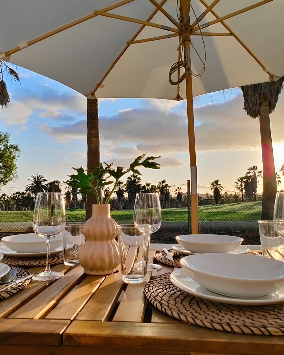 Terrace dining table with golf course view at sunset